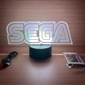 Letrero-logo Lampen Led Sega en Acrílico - Man Cave Cartel mega drive master system game gear weergeven