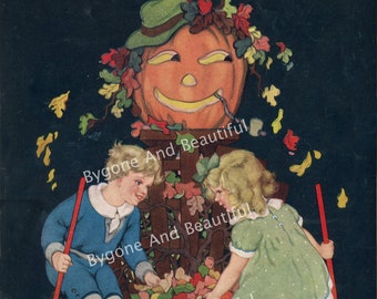 May include: Two children, a boy and a girl, are raking leaves into a basket in front of a jack-o-lantern. The jack-o-lantern is decorated with a green hat and autumn leaves. The children are wearing blue and green clothing. The background is dark blue.
