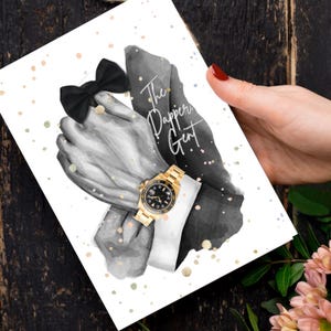 May include: Greeting card with a black and white illustration of a man's hands, a black bow tie, and a gold wristwatch. The text "The Dapper Gent" is written on the card. The card is held by a person with red nail polish.