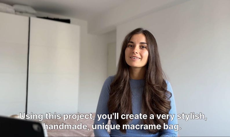 May include: A woman with long brown hair is smiling and looking at the camera. She is wearing a light blue sweater. The text "Using this project, you'll create a very stylish, handmade, unique macrame bag." is visible at the bottom of the image.