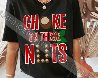 May include: A black t-shirt with the text "Choke on these Nuts" in red and white. The text is surrounded by a brown nut graphic.