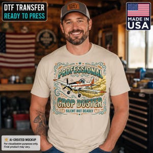 May include: A beige t-shirt featuring a graphic of an orange and white crop duster airplane. The text reads Professional Crop Duster and Silent But Deadly, surrounded by decorative teal and orange flourishes and a cloud of dust behind the plane.