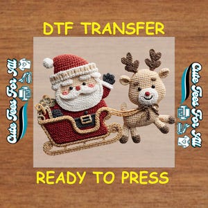 May include: A crocheted Santa Claus in a red sleigh pulled by a reindeer. The Santa has a white beard and hat. The image includes the text "DTF TRANSFER" and "READY TO PRESS".