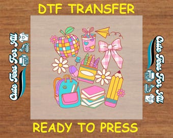 May include: A colorful DTF transfer design featuring school-themed illustrations. The design includes a plaid apple, backpack, pencils, books, and a bow. The text "READY TO PRESS" is at the bottom. The words "Cute Tees For All" are on the sides.