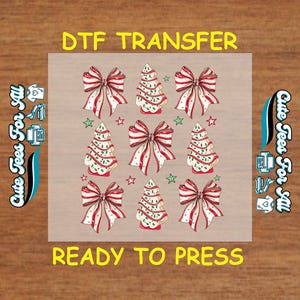 May include: DTF transfer sheet featuring a repeating pattern of Christmas bows and Christmas tree cookies. The bows are red and white, and the trees are decorated with green sprinkles. The text "DTF TRANSFER" and "READY TO PRESS" are displayed.