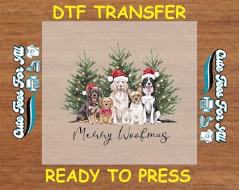 May include: A DTF transfer featuring a group of dogs wearing Santa hats in front of Christmas trees. The text "Merry Woofmas" is written below the dogs, with "DTF TRANSFER" and "READY TO PRESS" above and below the image.