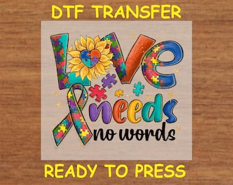 May include: A colourful iron-on transfer design featuring a sunflower with a jigsaw piece heart, a ribbon with jigsaw pieces, and the text "Love needs no words".