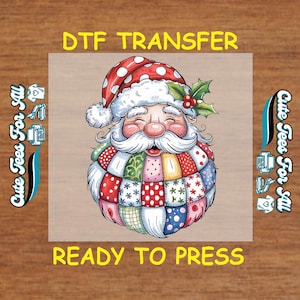 May include: A colorful DTF transfer featuring Santa Claus with a patchwork beard and a red and white polka-dot hat. The text "DTF TRANSFER" and "READY TO PRESS" are displayed in yellow. The image is on a light brown background.