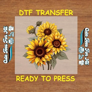 May include: DTF transfer featuring a vibrant bouquet of sunflowers with yellow petals and brown centers, set against a neutral background. The text "DTF TRANSFER" and "READY TO PRESS" are displayed in yellow. The words "Cute Tees For All" are on the sides.