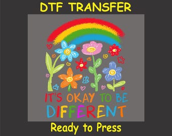May include: A colourful DTF transfer design featuring a rainbow, flowers, and the text "It's okay to be different". The design is ready to press.