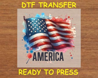 May include: A ready-to-press DTF transfer featuring a vintage-style American flag with watercolor splatters and the word "AMERICA" in bold letters.