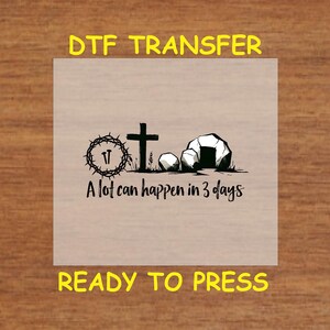 May include: A black and white illustration of a cross, a crown of thorns, and a tomb with the text "A lot can happen in 3 days".  The image is on a beige background and is ready to be pressed onto a surface.
