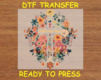 May include: A digital transfer design featuring a cross surrounded by colorful flowers. The text "Faith over Fear" is written on the cross. The design is ready to press.