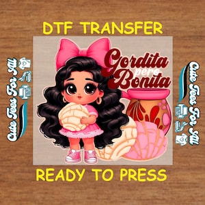 May include: A DTF transfer design featuring a cartoon girl with black hair, a pink dress, and a large pink bow. She holds a concha pastry. The design includes the text "Gordita pero Bonita" and "Ready to Press."