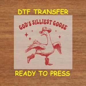 May include: Red and white iron-on transfer design featuring a cartoon goose wearing a cowboy hat and boots with the text "God's Silliest Goose".