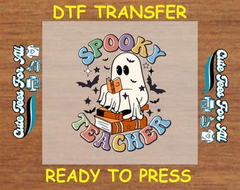 May include: A DTF transfer featuring a cartoon ghost reading a book, with the words "Spooky Teacher" in colorful, retro lettering. Bats and stars surround the ghost. The text "Ready to Press" is also included.