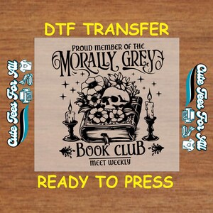 May include: Black and white graphic design of a book with a skull and flowers, with the text "Proud member of the Morally Grey Book Club - Meet Weekly".