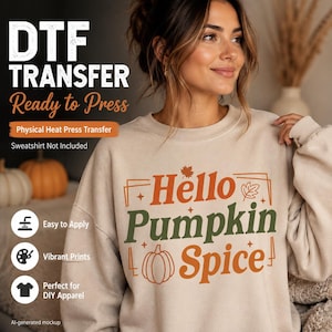 May include: A beige crewneck sweatshirt featuring a graphic print with the text Hello Pumpkin Spice in orange and green lettering, accompanied by illustrations of a pumpkin and leaves, framed by thin orange lines on the front of the garment.