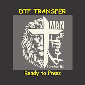 May include: A white iron-on transfer design featuring a lion's head with a cross behind it. The text "MAN OF FAITH" is written vertically on the cross. The text "I Corinthians 16:13" is written below the cross.