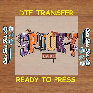 May include: A DTF transfer design with the word "SPOOKY" in orange, purple, and black, with a witch hat, bats, and a bow. The word "BABE" is below the word "SPOOKY". The text "DTF TRANSFER" and "READY TO PRESS" are also present.