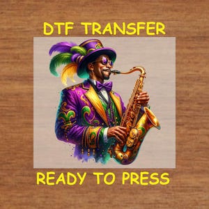 May include: A digital transfer design featuring a cartoon illustration of a person wearing a purple and green Mardi Gras costume playing a gold saxophone. The text "DTF TRANSFER" and "READY TO PRESS" is included in the design.