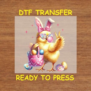 May include: A yellow chick wearing pink bunny ears, sunglasses, and a pink heart-shaped bag with colorful Easter eggs. The chick is holding a peace sign and blowing a bubble. The text "DTF TRANSFER READY TO PRESS" is at the top and bottom of the image.
