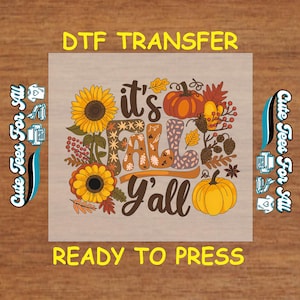 May include: A DTF transfer design with the text "it's FALL y'all" in a fall-themed design. The design includes sunflowers, pumpkins, and fall foliage. The words "DTF TRANSFER" and "READY TO PRESS" are also present.