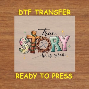 May include: A DTF transfer design featuring a colorful graphic of the word "STORY" with a cross and a crown of thorns. The text "true" is above the word "STORY" and the text "he is risen" is below. The design is ready to press.