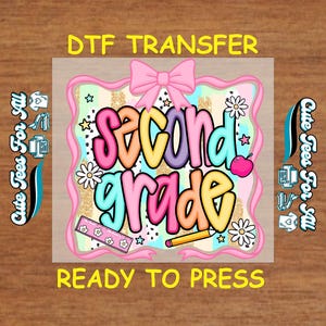 May include: A colorful DTF transfer design for second grade. The design features the words "Second Grade" in a bubble font, with a pink bow, stars, flowers, a ruler, a pencil, and an apple. The text "DTF TRANSFER" and "READY TO PRESS" are also included.