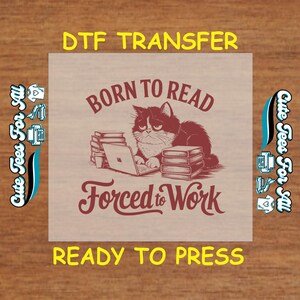May include: A red and white DTF transfer design featuring a cat sitting at a laptop with a stack of books. The text reads "Born to Read Forced to Work".