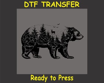 Könnte beinhalten: Schwarzweiß-Illustration eines Bären mit einer Waldszene in seiner Silhouette. Der Text "DTF TRANSFER" und "Ready to Press" befindet sich unter dem Bild.