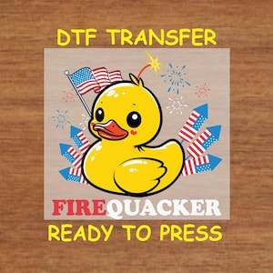 May include: A yellow rubber duck with a red, white, and blue American flag and fireworks behind it. The text "FIREQUACKER READY TO PRESS" is below the duck.