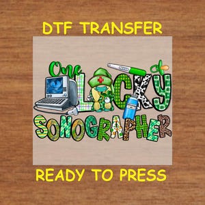 May include: A green, white, and black iron-on transfer design featuring a cartoon leprechaun holding a sonogram machine. The design says "One Lucky Sonographer" and is ready to press.