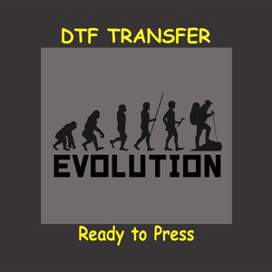 May include: A gray background with the text "DTG TRANSFER" in yellow at the top. A silhouette of the evolution of man, starting with a primitive ape and ending with a hiker carrying a backpack and a walking stick. The text "EVOLUTION" is below the silhouettes in black. The text "Ready to Press" is at the bottom in yellow.