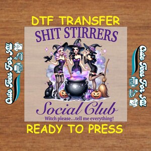 May include: DTF transfer featuring three cartoon witches in black dresses and hats, stirring a cauldron. The text reads "SHIT STIRRERS Social Club" and "READY TO PRESS". A black cat, pumpkins, and a broom are also visible.