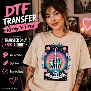 May include: A DTF transfer design featuring a skeleton hand making a middle finger gesture inside a rectangular frame. The graphic includes pink flowers, blue leaves, and a rainbow sunburst background with the text THE ZERO OF FUCKS.