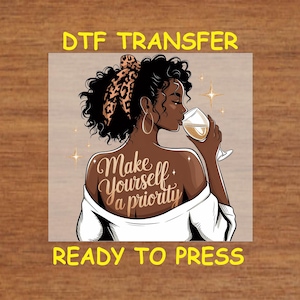May include: A digital transfer design featuring a woman with dark skin and curly black hair, wearing a white shirt and a leopard print headband. She is holding a glass of wine and the text "Make yourself a priority" is written on her back.