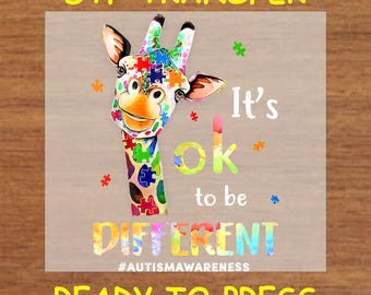May include: A colourful giraffe design with puzzle piece patterns, the text "It's ok to be DIFFERENT" and "#AUTISMAWARENESS". The image is labelled "DTF TRANSFER" and "READY TO PRESS".
