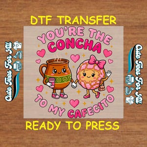 May include: A DTF transfer featuring a cartoon illustration of a brown coffee cup holding a pink cup and a pink concha pastry holding a purse, with the text "You're the Concha to my Cafecito". The design includes pink hearts and the words "Ready to Press".
