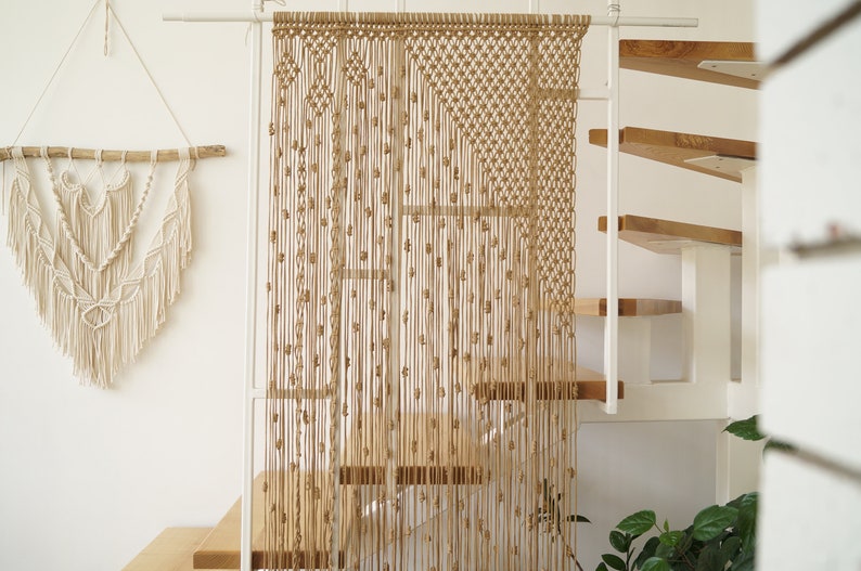 Macrame curtain with asymmetrical pattern, diamond patterns and lots of knots.