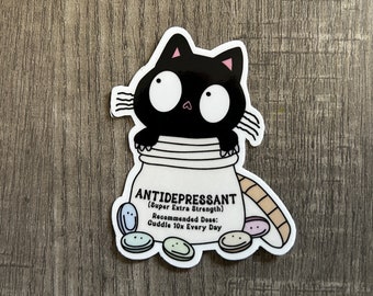 May include: A black cat with big eyes is inside a white pill bottle labeled "ANTIDEPRESSANT (Super Extra Strength)". The recommended dose is "Cuddle 10x Every Day". There are colorful pills spilling out of the bottle.