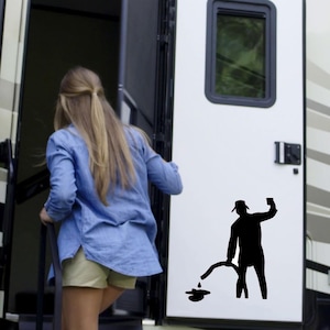 May include: A black silhouette of a person holding a hose and pouring liquid on the ground. The silhouette is on the side of a white RV.
