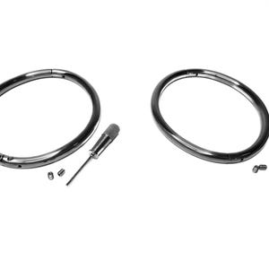 May include: Two silver metal rings with a small screwdriver and two screws. The rings are open and have a gap in the metal.