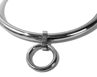 May include: A silver metal choker necklace with a round ring pendant.