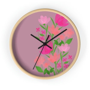 May include: A pink and green floral design on a round clock face with black clock hands.