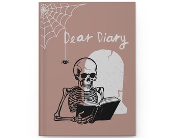 May include: A brown journal with a skeleton reading a book. The journal has the words "Dear Diary" written on the front. There is a spider web and a spider in the top left corner.