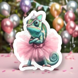 May include: A green chameleon wearing a pink tutu and a crown. The chameleon is standing on a white background.
