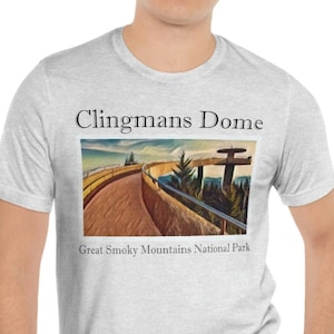 May include: A heather grey t-shirt with a graphic of a winding road and the text "Clingmans Dome Great Smoky Mountains National Park".