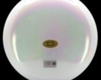 May include: A pearlescent white disc golf disc with a subtle iridescent sheen. The disc has a circular shape with a slightly raised edge. A small, gold-colored emblem is in the center, and a small sticker is at the bottom.