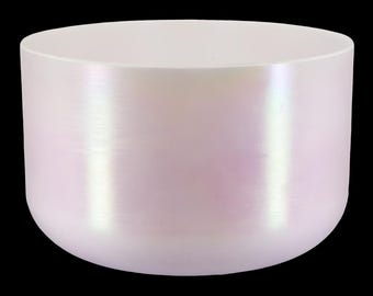 May include: A pearlescent white crystal singing bowl with a rounded cylindrical shape. The bowl has a smooth, polished surface that reflects light, creating a subtle iridescent effect. The bowl is designed for sound healing and meditation.